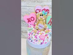 there is a cake decorated with teddy bears and hearts