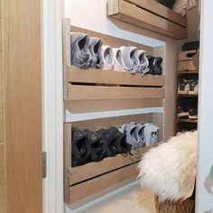 there are many pairs of shoes on the shelves in this closet, and one is empty