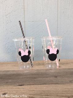 two cups with minnie mouse straws on them