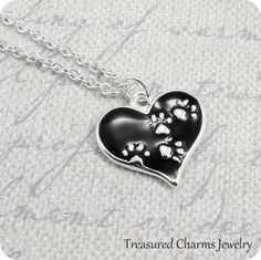 This  Heart with Paw Prints Charm necklace comes on a silver-plated chain that is available in different lengths. Please choose your desired length from the drop-down menu when placing the item in your shopping cart. { CHARM DETAILS }★ Material: Pewter and Enamel★ Finish Color: Silver★ Measurements: 3/4" x 3/4"★ Dimensions: 2-sided{ SIMILAR ITEMS } More pet themed items available from my shop: https://www.etsy.com/shop/treasuredcharms/search?search_query=animal+rescue{ GIFT OPTIONS}Gift boxes ar Silver Heart-shaped Cat Design Jewelry, Cat Memorial Jewelry, Cat Paw Necklace, Paw Print Pendant, Dog Lover Jewelry, Paw Necklace, Paw Print Necklace, Paw Print Charm, Animal Room