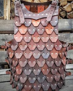 a leather vest made to look like hexagonal shapes with metal rivets