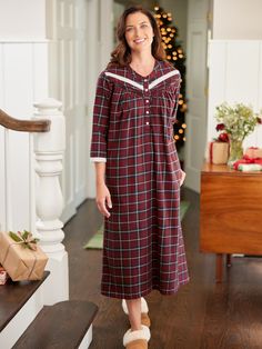 This lightweight flannel nightgown inspires cozy nights spent reading a book by the fire and sipping hot cocoa. The soft brushed cotton flannel and roomy fit leave you feeling comfy, and the pretty lace isn't the only detail you'll love! This flannel nightgown also features pintuck accents, a banded collar, 3/4 sleeves, and a rich plaid with a festive look, making this nightgown great for the holidays and beyond! Lightweight brushed flannel Longer length Beautiful red berry plaid with a pop of charcoal gray Classic Henley neckline Button placket Soft lace trim around neckline and cuffs 3/4 sleeves Horizontal pintucks Side-seam pockets Approx. 50" long 100% cotton Machine wash and dry Imported Exclusive to The Vermont Country Store Coordinating Ella Simone Lace and Plaid Cotton Flannel Paja Red Cotton Nightgown For Loungewear, Red Fall Sleepwear, Red Sleepwear For Fall, Red Long Sleeve Nightgown For Home, Long Flannel, Flannel Nightgown, Vermont Country Store, Country Store, Sleepwear & Loungewear