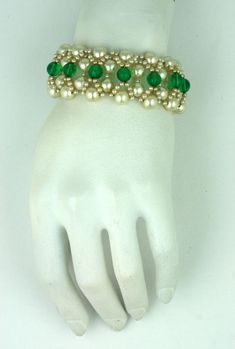 Elaborate woven bracelet by Louis Rousselet, Paris circa 1940s. High quality faux pearls and emerald pate de verre beads are used for this bracelet and earring combination. Excellent condition. Green Beaded Evening Jewelry, Elegant Green Pearl Bracelet, Formal Beaded Costume Jewelry Bracelets, Elegant Green Beaded Pearl Bracelet, Elegant Festive Bracelets With Spacer Beads, Elegant Handmade Green Pearl Bracelet, Elegant Green Beaded Bracelets For Festive Occasions, Elegant Green Beaded Bracelets For Formal Events, Elegant Green Beaded Bracelets For Formal Occasions