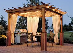 a gazebo sitting on top of a brick patio next to a table and chairs