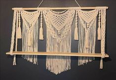 a macrame hanging on a wall with tassels