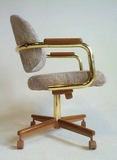 an office chair with wooden legs and a beige upholstered seat