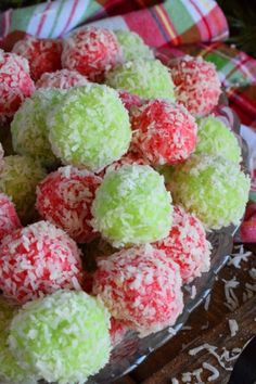 a bowl filled with green, red and white sprinkles on top of a table