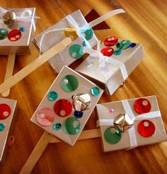 there are several boxes with buttons on them and tied to clothes pins, sitting on the floor