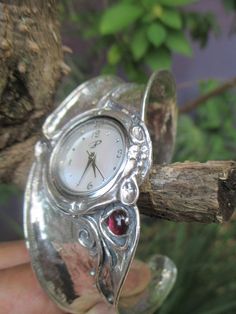 From Porans Watches collection: Unique Silver Bohemian Flexible Cuff Watch with gemstone: TURQUOISE/AMETHYST/GARNET/ PEARL/MOONSTONe/OPAL inlaid. Dimensions: Front Width: 36 mm\ 1.44 inches. Back width: 14 mm\ 0.56 inches. Size: Can fit any wrist Our watch is top quality stainless still, analog, Japanese movement with water resistance (up to 3 atmospheres) and it is powered by a battery that lasts about 3 years. The battery can be exchanged. Please notice that because the watch is made to order Handmade Elegant Formal Watches, Elegant Handmade Formal Watches, Cuff Bracelet Strap Watches, Timeless Analog Jewelry For Anniversary, Engraved Cuff, Watches Collection, Cuff Design, Freshwater Pearl Ring, Women Design