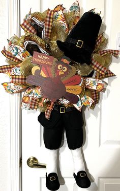 a scarecrow door hanger with a happy thanksgiving card on it