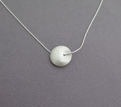 Delicate silver necklace for yourself or as a gift, with a unique bead. Both sides of the bead look the same, it's diameter is about 1.6 cm - 0.6 inch, with a grainy textured matte finish. The chain is 40 cm/16 inch long. Please contact me if you like to have a longer chain. I also have this necklace in 14k gold, with a smaller bead, here: https://www.etsy.com/listing/74255864 For another version of this necklace, click here: https://www.etsy.com/listing/79578221 To get back to my shop, click he Silver Ball Chain Necklace As A Gift, Silver Necklace With Ball Chain As Gift, Silver Necklace With Ball Chain For Gift, Minimalist Silver Beads Round Jewelry, Minimalist Round Silver Beads Jewelry, Sterling Silver Necklaces With Pearl Pendant And Round Beads, Silver Beads Round Pendant For Gift, Silver Pendant Jewelry With Spacer Beads, Nickel Free Sterling Silver Necklace With Round Beads