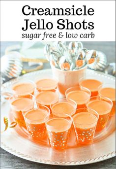 orange jello shots on a white plate with text overlay that reads, creamsice jello shots sugar free & low carb