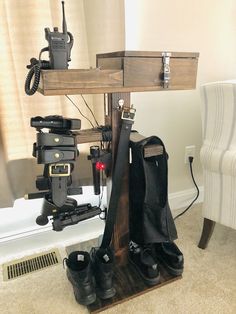 a pair of black shoes sitting on top of a wooden stand