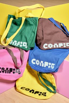 four bags sitting next to each other on top of a wooden floor with the word campa printed on them