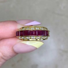 "This stunning ring crafted around the 1970s, boasts a classic design with eight-carre cut rubies totaling around approx 0.80 carats, Surrounding these rubies are eighty round brilliant cut diamonds in horizontal rows, with a combined weight of about 0.96 carats. made of 18k yellow gold. The ring measures approximately 5.26mm in width. ✦ GEMSTONE SPECIFICATIONS: Center Stone: Ruby Ruby Weight: Approx 0.80 Carats Ruby Cut: Carre' Cut Diamond Cut: Round Brilliant Cut Total Diamond Weight: Appro x0 Ruby And Diamond Ring, 18k Yellow Gold Ring, Ring Crafts, Yellow Gold Ring, Ruby Ring, Round Brilliant Cut Diamond, Diamond Cut, Yellow Gold Rings, Rings Statement