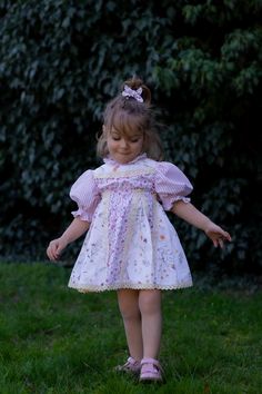 Our Patchwork Dress perfectly blends comfort and style. It combines different patterns, resulting in a romantic and unique dress. Crafted from soft, breathable, 100% cotton fabric, it ensures your child stays comfortable all day, whether they are attending a family gathering, a birthday party, or simply enjoying a day out.  The circle skirt allows for movement, perfect for twirling and dancing, while the soft shirring defines the waist for a perfect fit, without compromising comfort. The hem, go Spring Dress With Smocked Bodice For Playdate, Cottagecore Puff Sleeve Dress With Ruffles For Garden Party, Cottagecore Puff Sleeve Dress For Garden Party, Cute Puff Sleeve Dress With Ruffles For Garden Party, Cute Puff Sleeve Dress With Ruffles, Prairie Dress With Puff Sleeves For Garden Party, Cottagecore Dress With Smocked Back And Puff Sleeves, Cottagecore Dress With Puff Sleeves And Smocked Back, Cotton Dresses With Balloon Sleeves