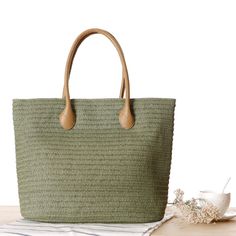 This bag is stylish and very pretty. It is a classic, elegant solid color design.Whether you are out shopping, going to the pool or the beach, this tote bag is the perfect accessory. Spacious enough for carrying any and all of your seaside essentials. Straw Beach Tote, Rattan Handbags, Summer Purses, Straw Beach Bag, Straw Tote Bag, Rattan Bag, Handmade Tote, Top Handle Handbags, Straw Tote