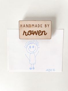 a rubber stamp with the words handmade by rowan on it and a drawing of a boy