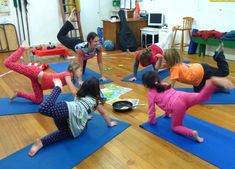 a group of people doing yoga in a room