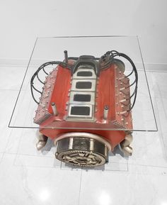 an engine is shown on display in a glass case with the top section showing it's front end