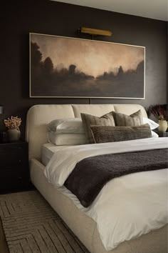 a bedroom with a large painting above the bed