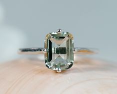 This classic compass style solitaire setting contains a beautiful 3.00ct natural emerald cut prasiolite, also called green amethyst. This unique setting has prongs in a north, south, east and west configuration. The emerald cut stone measures approximately 9x7mm and the band is 2mm wide. The ring is available in sterling silver, and 14k white, yellow, or rose gold. This ring makes a unique promise or engagement ring. Please send me a message if you need a size not listed. * This ring can be cust Green Gem Rings, Colored Wedding Rings, Green Amethyst Engagement Ring, Gold Band Engagement Rings, Green Engagement Rings, Prasiolite Ring, Amethyst Ring Vintage, Turquoise Ring Engagement, Amethyst Ring Engagement