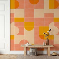 an orange and pink wallpaper in a living room with a wooden table next to it