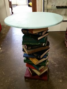 a stack of books sitting on top of a table in the middle of a room