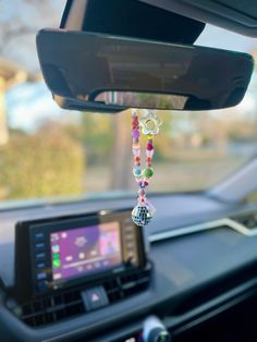 a car dashboard with beads hanging from it's dash board