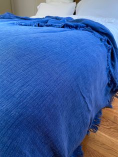 a blue blanket on top of a wooden floor