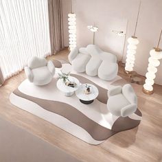 a living room filled with white furniture on top of a hard wood floor