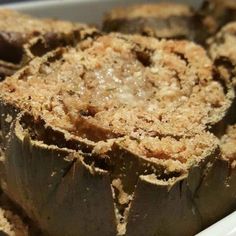 an artichoke is sitting in a white dish