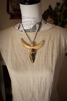 This necklace is made from resin fangs and claws handmade by us with carved runes. Wooden beads have been added, the easily adjustable cord completes the whole thing. All our products are entirely handmade. Every single piece was sculpted, then reproduced in resin, painted and decorated by hand, paying attention to detail. The colors used are water-based, resistant to UV rays and rainy days. At the end of the work everything is covered with a fixative varnish. -As with all our items we recommend caution when handling them, as some decorations are created with natural and delicate elements. -For any info or request contact us here or on IG @labottegadipan * NOT refundable, NOT returnable ** Buyers are responsible for any customs costs.  I'm not responsible for any delays caused by customs c Handmade Black Necklace For Larp, Necromancer Necklace, Handmade Medieval Necklaces For Larp, Druid Necklace, Teifling Horn Jewelry, Animal Bone Necklace, Paying Attention, Uv Rays, Rainy Days