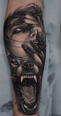 a man's leg with a tattoo on it and an image of a wolf