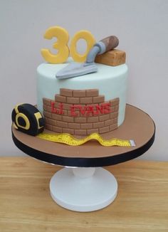 a birthday cake for someone's 30th birthday with the number 30 on it and construction equipment