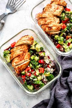 two plastic containers filled with chicken and salad on top of a white tablecloth next to a fork