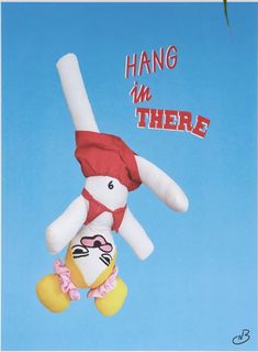 a stuffed animal hanging from the side of a blue sky with words hang in there