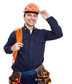 a man wearing safety gear and an orange hard hat is posing for the camera with his hands on his head