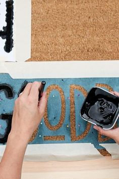 a person is using a paintbrush to decorate a door