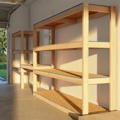 the inside of an empty building with shelves on each side and doors to another room