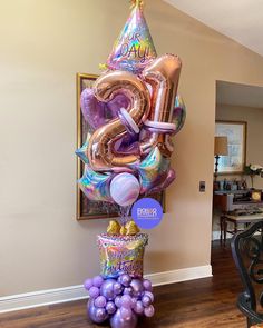 a birthday balloon tower with balloons in the shape of numbers