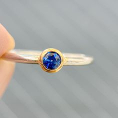 This Sapphire Ring has a 14K Solid Gold Setting and an S925 Silver Band.  Perfect for a wedding or anniversary ring. Perfect gift for mom, a gift for her, or a birthday gift. Sapphire is the birthstone for September. They are the stone of new love and commitment and represent one's faith and hope in their romantic partner. Item Description: - The main stone is 4mm Round Cut. - Color: Dark Blue. - Transparency: Exellence. - Size: All Popular Size - Material: Solid S925 Silver Band. 14K Solid Gold Minimalist Sapphire Ring With Bezel Setting For Everyday, Everyday Fine Jewelry Birthstone Ring With Bezel Setting, Yellow Gold Sapphire Stackable Rings With Bezel Setting, Sapphire Stackable Birthstone Rings, Fine Jewelry Sapphire Stackable Rings With Bezel Setting, Everyday Gold Stackable Sapphire Ring, Fine Sapphire Stackable Rings With Bezel Setting, Gold Dainty Sapphire Birthstone Ring, Stackable Minimalist Sapphire Ring With Round Band