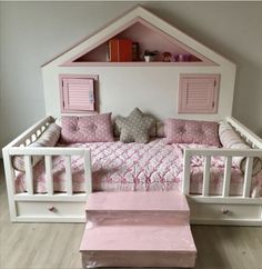 a dollhouse bed with pink and white furniture