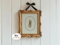 a small framed animal is hanging on the wall