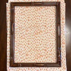 an orange and white polka dot fabric with bamboo frame