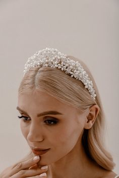 Pearl Regalia Headband Elevate your bridal hairstyle with Pearl Regalia Headband, featuring clear glass and pearls. This accessory adds a touch of timeless elegance to any wedding day look, with delicate detailing that sparkles in the light. Whether you're wearing your hair up or down, this headband is the perfect finishing touch to complete your bridal ensemble. Pearl Bridal Headband With Veil, Pearl White Pearl Bridal Accessories, Beaded Hair Accessories For Wedding, Adjustable Wedding Crown, Adjustable Pearl Bridal Accessories For Wedding, Elegant Adjustable Bridal Accessories, Silver Headband Crown For Wedding, Adjustable Wedding Hair Accessories With Structured Crown, Adjustable Hair Accessories With Structured Crown For Wedding