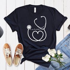 ABOUT OUR Nurse Stethoscope Shirt, Custom Nurse Shirt, Nurse Shirt, Nursing School Tee, Nurse Loyal Hello everyone! Welcome to Ricardo Zarate store. Here, you'll find a wide selection of affordable, high-quality personalized designs and unique creations perfect for your friends, family, coworkers, and loved ones. Our prints are created using the latest technological materials, ensuring exceptional quality. Each order is meticulously prepared using top-quality inks during the production process. Cotton Graphic Print Nursing Shirt, White Cotton Nursing Shirt, Cotton Graphic Print Tops For Nursing, Cotton Graphic Print Nursing Tops, Cotton Short Sleeve Nursing Shirt, Cotton Short Sleeve Nursing Tops, Short Sleeve Cotton Nursing Tops, Cotton Nursing Tops With Graphic Print, White Short Sleeve Nursing Shirt