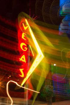 the neon sign is lit up for us to see it's light show at night