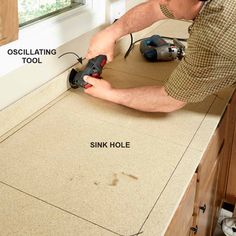 a man sanding the counter top with a power drill and an oscillating tool