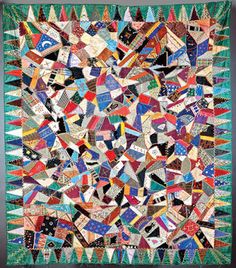 a colorful quilt with many different colors and patterns on it's sides, including triangles